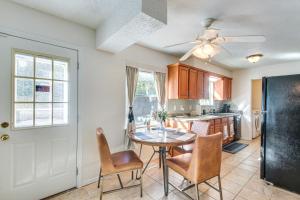 a kitchen with a table and chairs and a refrigerator at 3 Mi to Diamond Ballroom Home with Fenced Yard! in Oklahoma City