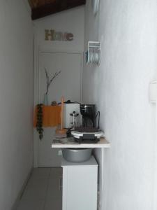 a kitchen with a counter with a coffee maker on it at La Plus Grande Source D'eaux Chaudes " Guadeloupe " in Bouillante