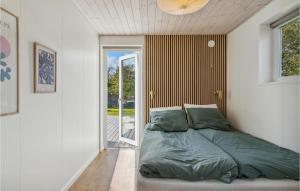 a bedroom with a bed and a sliding glass door at Stunning Home In Gilleleje With Wifi in Gilleleje