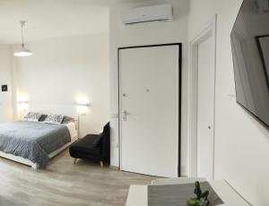 a bedroom with a door leading to a bed at Town Center Apartment in Cagliari
