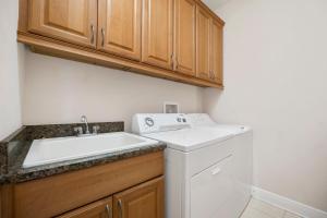 a kitchen with a sink and a washing machine at Wave Runner in Flagler Beach