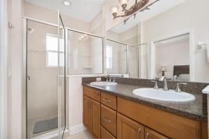 a bathroom with two sinks and a shower at Wave Runner in Flagler Beach