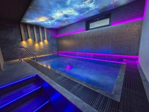 a hot tub with purple lights in a room at Apartmány Jarmilka in Bedřichov