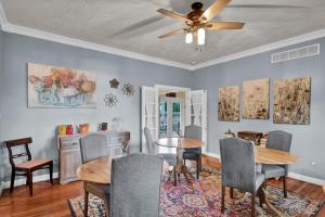 a dining room with a ceiling fan and tables and chairs at Hill House Bed and Breakfast in Loretto