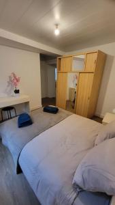 a bedroom with two beds and a table at Le QG in Saint-André-de-Cubzac