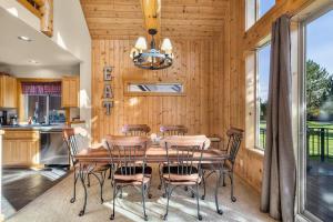 a wooden dining room with a table and chairs at Oregon Chalet in Redmond