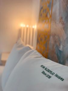 a bed with a white pillow and a radiator at Zambujeira Lounge in Zambujeira do Mar +43 photos