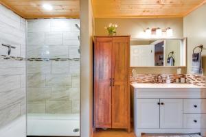 a bathroom with a shower and a sink at Lakemont Mountain Cabin with Game Room and Hot Tub! in Lakemont +33 photos