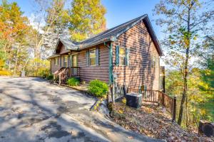 a home in the woods with a driveway at Lakemont Mountain Cabin with Game Room and Hot Tub! in Lakemont