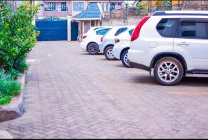 a row of cars parked in a parking lot at Olive Homes Thika Town in Thika