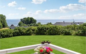 a view of a yard with green grass and flowers at Holiday Home Harresbæk Iii in Skovby +11 photos