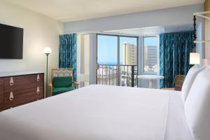 a bedroom with a large bed and a large window at Waikiki Malia in Honolulu