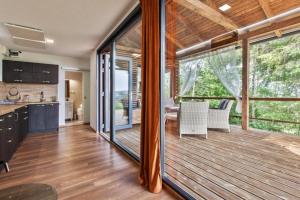 a kitchen and living room with a large glass door at Chata Glianka in Brezno