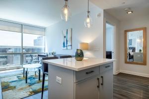 a kitchen with a counter and a dining room at Luxury Apt with Gym & Pool in Stamford