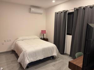 a bedroom with a bed and a television in it at Residencial Sabina in Cabo San Lucas +23 photos