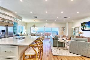 a kitchen and living room with a view of the ocean at View West #1 in Clearwater Beach