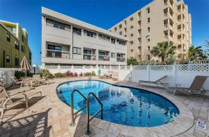 a swimming pool in front of a building at View West #1 in Clearwater Beach