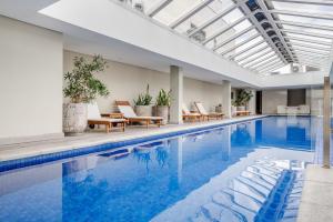 a swimming pool with lounge chairs and a poolside at Trend NCG - Apartament 1602 in Porto Alegre