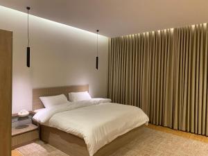 a bedroom with a bed and a large window at دار نوره وحدة سكنية في منتصف جدة in Jeddah