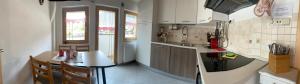 a kitchen with a table and a counter top at Villa Alessandra in Colle Isarco