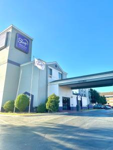 a store with a sign on the side of a building at Sleep Inn & Suites Tulsa Central I-44 in Tulsa