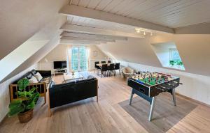 a living room with a foosball table in the middle at Beautiful Home In Blåvand With Sauna in Blåvand