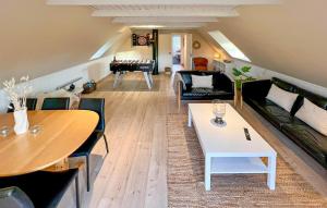 a living room with a couch and a table at Beautiful Home In Blåvand With Sauna in Blåvand