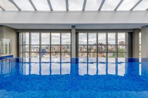 a swimming pool with a view of a building at Trend Nova Carlos Gomes - 406 in Porto Alegre