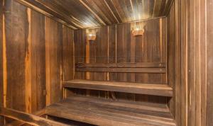 an empty sauna with wooden walls and wooden stairs at Trend Nova Carlos Gomes - 406 in Porto Alegre