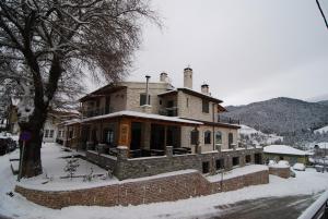 a large brick house with snow on the ground at Lithos in Áyios Nikólaos