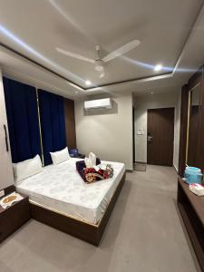 a bedroom with a large bed with a ceiling at HOTEL PREMIER CHOICE - JUST 50 Meters FROM AJMER SHARIF DARGAH in Ajmer