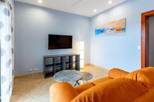 a living room with a couch and a table at 2 Bedroom Ocean-View Condo with Pool in Playa Flamingo