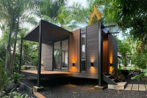a small house with glass doors on a street at Tiny House by HYTTE HOMES in Panama City