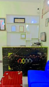 a classroom with a blue chair and a wall with signs at Malinum Grande Guest House in Lahore