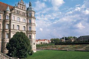a large building with a tree in front of it at sweet dream hostel & pension - Self Check-In in Güstrow