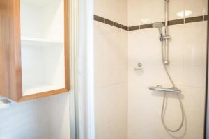 a bathroom with a shower with a shower head at Weidevilla XXL in Hollum +43 photos