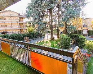a balcony with an orange railing in a park at FlyBGY in Orio al Serio