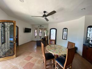 a dining room and living room with a table and chairs at Casa Kahakai 1 in Chacala