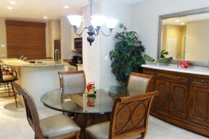 a kitchen and dining room with a glass table and chairs at Ground-Floor Unit in Front of Lazy River Pool at Pacifico in Coco in Coco