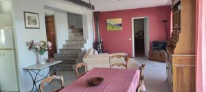 a living room with a table and a bed at Le Mas du 1934 in Lorgues