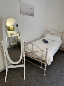 a bedroom with a bed and a mirror at Lord Nelson Hotel in Bridport
