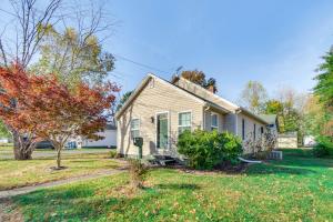 a white house with a tree in the yard at Hike, Boat and Fish Dog-Friendly Robinson Home in Robinson