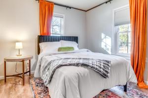 a bedroom with a bed with an orange curtain at Hike, Boat and Fish Dog-Friendly Robinson Home in Robinson