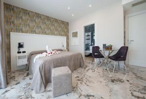 Postel nebo postele na pokoji v ubytování Hotel Manuela