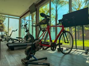 a bike parked in a gym with several exercise bikes at Hotel Casa María in Tlalixtac de Cabrera