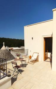 a patio with chairs and a table on a building at Massì bnb in Locorotondo +32 photos
