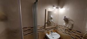 a bathroom with a sink and a mirror at Vila Zvončica, apartman Puzović 22 in Kopaonik