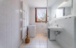 a white bathroom with a sink and a toilet at Ostseebad-Karlshagen-grosszuegige-Ferienwohnung-Sommer in Ostseebad Karlshagen +17 photos