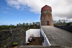 a brick lighthouse sitting on top of a building at O Moinho Da Bibi in Candelária +22 photos