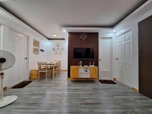 ein Wohnzimmer mit einem Tisch und einem Fernseher in der Unterkunft Casa Danico - 2 BR Spacious unit in Antipolo in Maagay